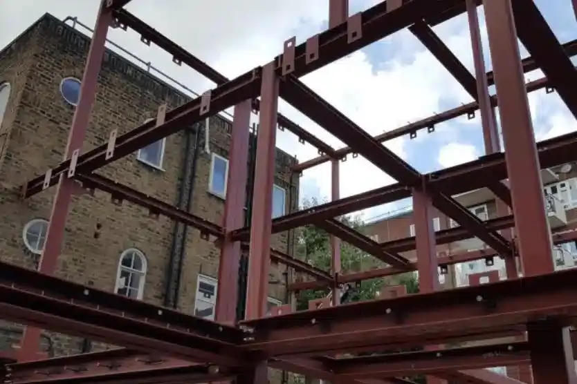 Primed beam and column frame erected between London terraces