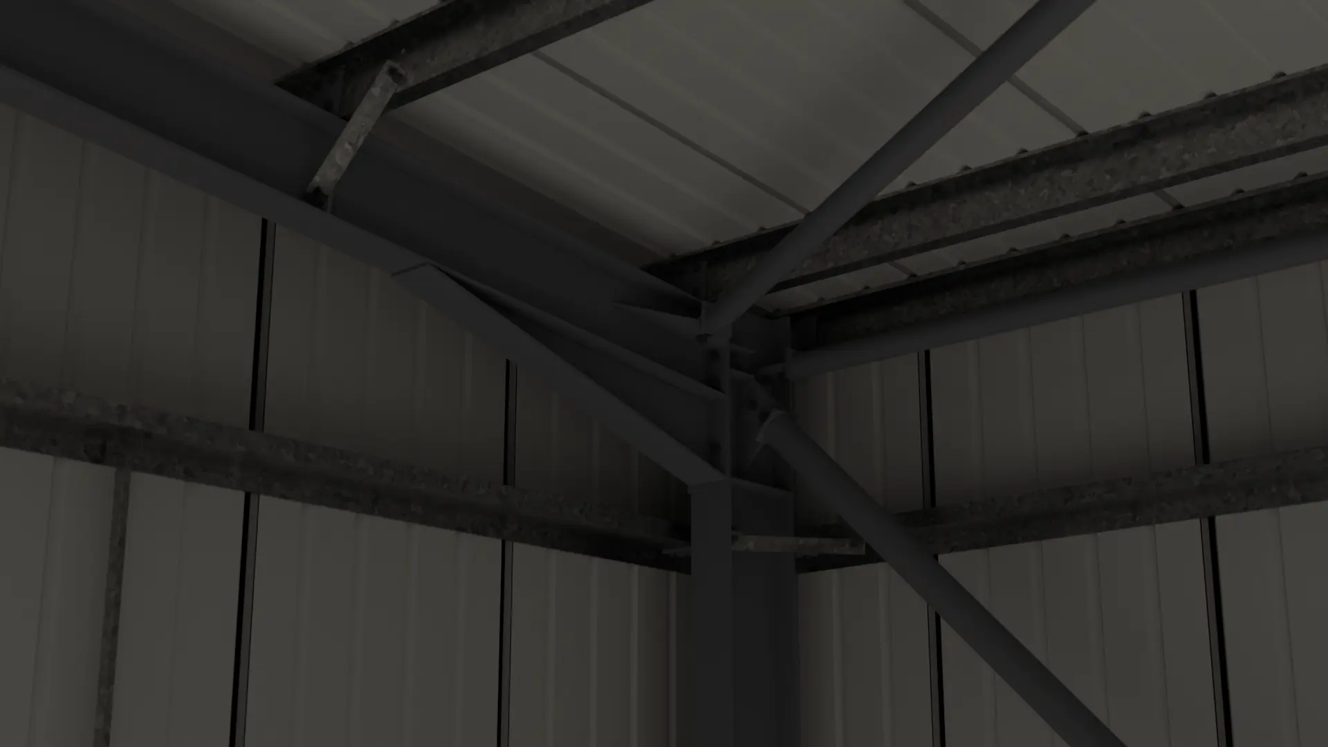 Dark interior view of portal frame bracing beneath the roof sheets